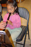 Student Playing Recorder for Music Lessons